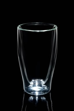 Empty double walled coffee glass isolated on black clipart