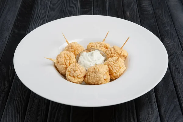 Snack for beer - deep fried cheese balls with sauce.