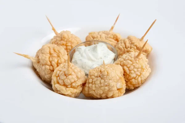 Snack for beer - deep fried cheese balls with sauce.