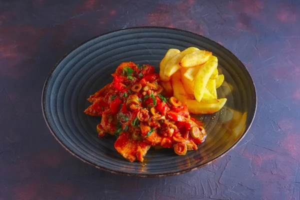 Portuguese  goulash with tomato and olives sauce and fried potato
