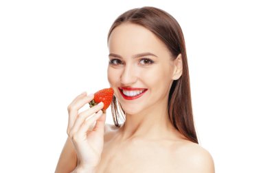 Beautiful happy girl with clean and fresh skin eating strawberry. Cosmetology , treatment, beauty and spa . Skin care and aromatherapy.