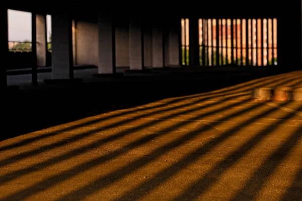 Ligth and shadows of the columns on the floor of the building with parking