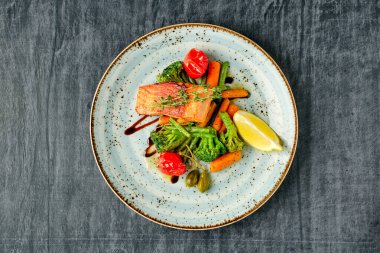 Fırında somon, kızarmış havuç, brokoli, yeşil fasulye ve domates vişneli.