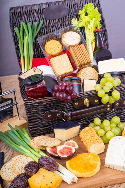 Cheese Hamper.Wicker Hamper full of cheese, crackers with a selection of pickles and fruits.