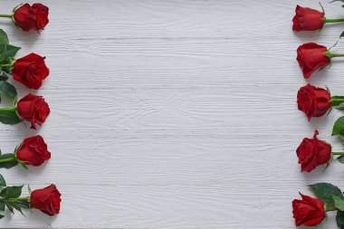 Çerçeve beyaz ahşap zemin üzerinde kırmızı gül. Metin için ile yer
