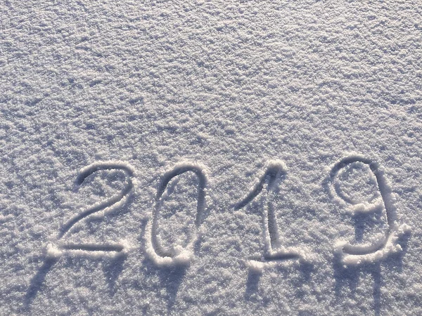 2019. Writings on the snow. Happy new year. Beautiful cold sunny winter day.  The game of light and shadow