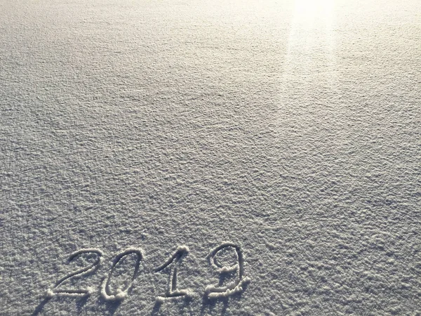 2019. Writings on the snow. Happy new year. Beautiful cold sunny winter day.  The game of light and shadow