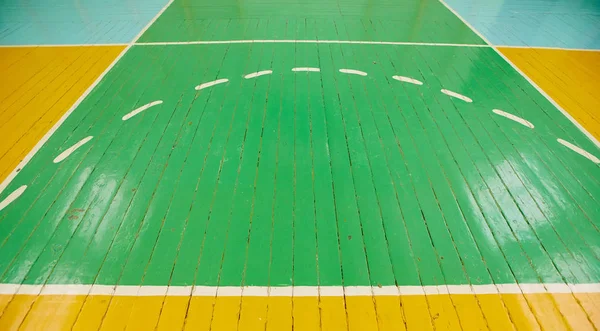 Antiguo piso agrietado de la sala de deportes con marcas para el baloncesto — Foto de Stock
