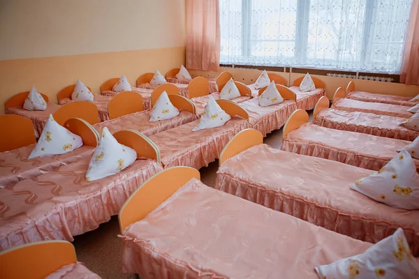 Ліжка та ліжка в яскраво-кольоровому гуртожитку дитячої.Багато дитячих ліжечок — стокове фото