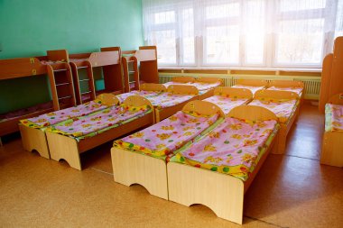 Beds in a boarding school, orphanage, center for displaced children, refugees or in a temporary accommodation center clipart