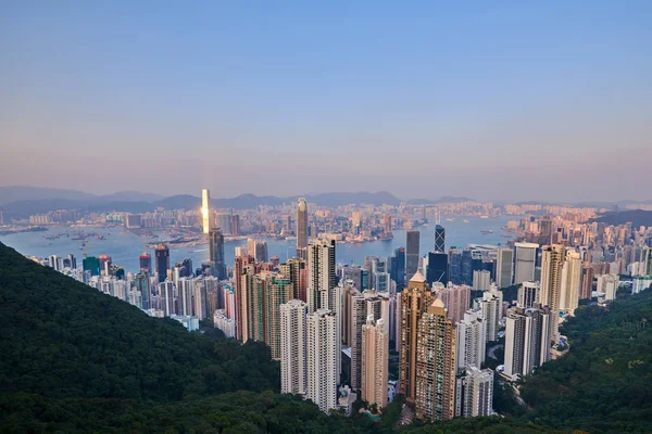 Hong Kong şehir manzarası görünümünden Victoria peak gökdelenler binalar gün batımında.
