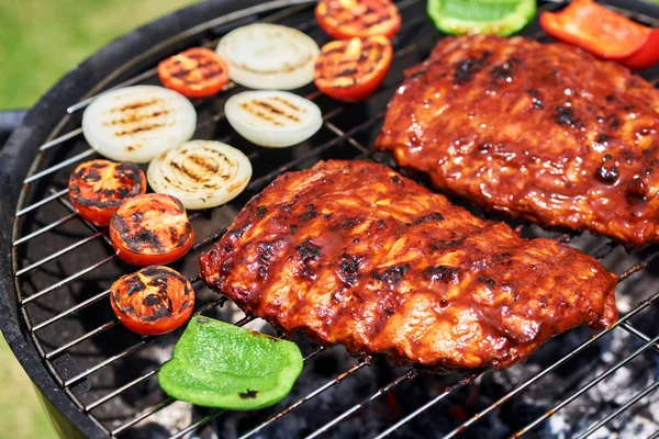 Delicious pork ribs on garden grill, close-up