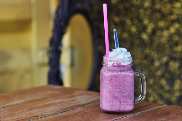 Well being and weight loss concept.  Raspberry and blueberry smoothie. Homemade antioxidant summer berry smoothie on rustic table.  Smoothie summer dessert for well being and healthy lifestyle.