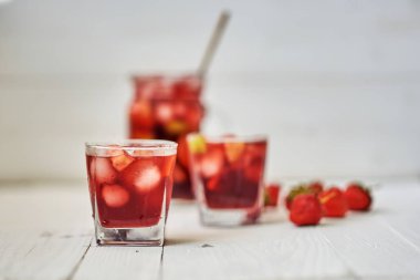 Ferahlatıcı sangria veya gözlük ve sürahi ile meyve punch. Geleneksel yaz içki içecek. Kırmızı şarap, çilek, portakal, limon ve yeşil elma. Bir ahşap rustik masaya kopya alanı ile