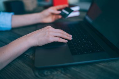 Seçici odak. Smartphone ve kredi kartı ve dizüstü bilgisayar kullanan genç kadın iş ve onun çalışma salonu arama online alışveriş bağlı. Onun online sipariş onay için bekleyen iş kadın