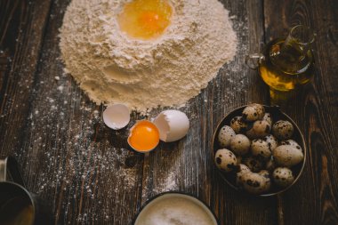 Yemek, yemek ve pişirme kavramı. Rustik mutfakta ekmek. Hamur tarifi Malzemeler yumurta, un, süt, yukarıdan karanlık vintage ahşap masa üzerine. Kırsal mutfak. Ev yapımı yiyecek.