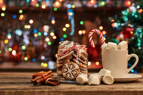 Gingerbread  with mug of hot chocolate and candy cane.