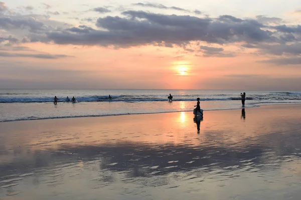 Günbatımında sörf tahtaları çocukla siluet.
