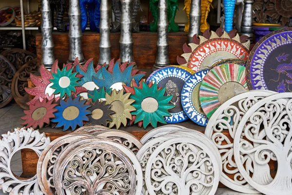 Handmade wooden carved souvenirs with weathered natural texture. Colorful gifts, nice memories of vacation.Souvenirs in art and craft  market. Selective focus and blurred background with copy space.