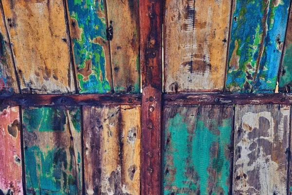 Creative wood background. Patterned and textures background of brightly colored planks. Room interior vintage with colorful wooden tiles. Art of colorful color on wooden wall. Weathered painted wood.