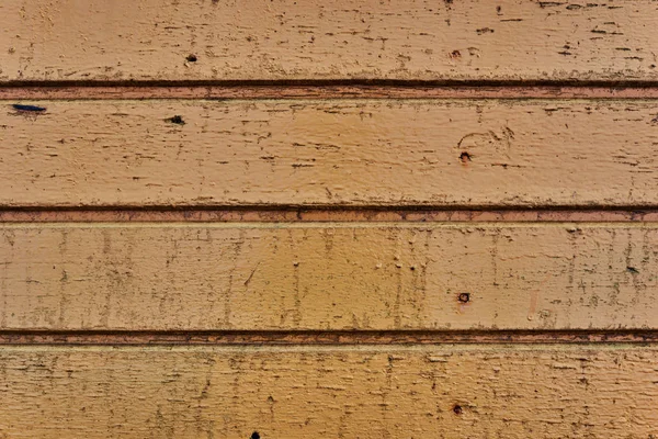 Painted yellow wood shabby horizontal background. Wooden barn wall rustic texture.