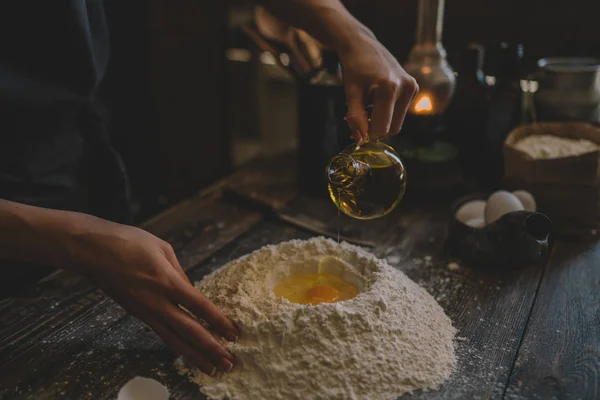 Steps of making cooking pie with ingridients. Mixing ingredients: flour, eggs, oil. See series. Step by step recipe. Cooking course or kitchen mess. Female hands make dough for biscuit or pie.