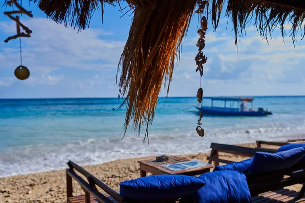 Wooden sunbed for relaxing on the paradise beach. Tropical recreational for vacation. Summer morning ocean view. Tropical sea resort beach serene scene. Relaxing atmosphere. Travel concept.