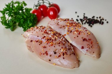 Çiğ çiğ tavuk fileto yemek için-malzemeler bir kesme masada sarımsak, biber, domates, otlar ve hakkındaki. Diyet, sağlıklı düşük kalorili gıda, kavramı kaybetmek ağırlık. Seçici odak.