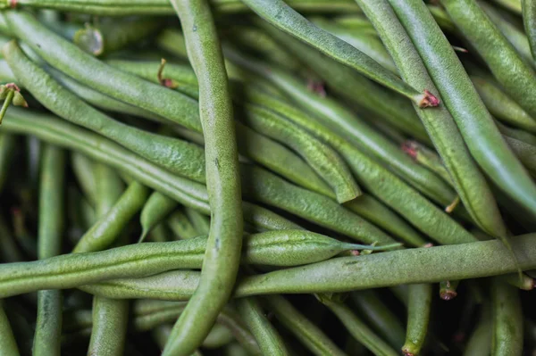 Fresh green string bean in the market for cooking. Long beans or french beans. Food background.