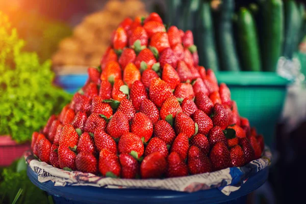 Colorful fruits and vegetables in the marketplace. Bright summer background. Healthy vegetables, food, raw ingredient. Natural nutrition for diet. Organic vegetables. Summer crops. Selective focus.