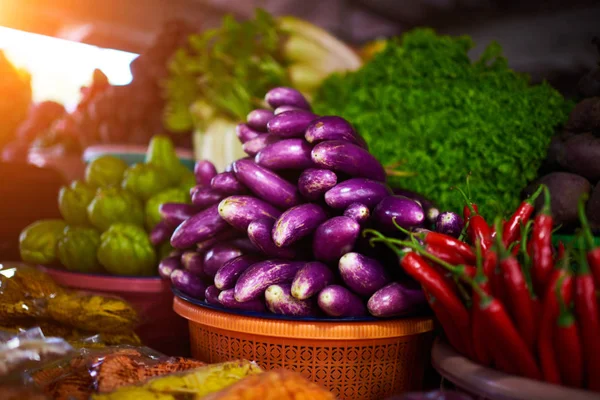 Colorful fruits and vegetables in the marketplace. Bright summer background. Healthy vegetables, food, raw ingredient. Natural nutrition for diet. Organic vegetables. Summer crops. Selective focus.