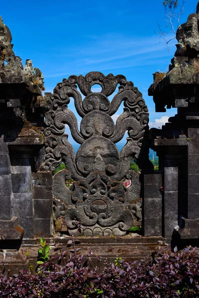 Beautiful view of ancient stone carving of temple on Bali island. Balinese hindu temple ornamented by carvings and sculptures. Old hindu architecture, ancient design. Summer and vacation concept.