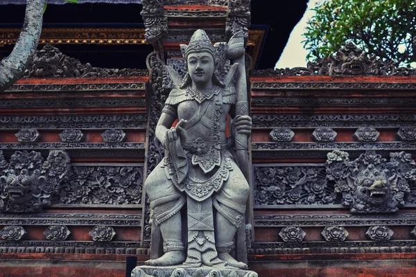 Beautiful view of ancient stone carving of temple on Bali island. Balinese hindu temple ornamented by carvings and sculptures. Old hindu architecture, ancient design. Summer and vacation concept.