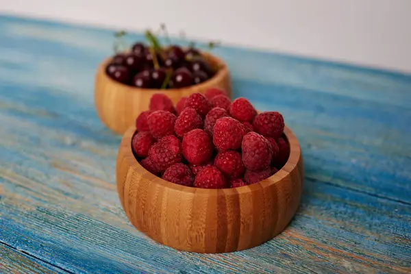 Housewife Posted Fresh Raspberries Cherries Beautiful Wooden Bowls — Stock Photo, Image