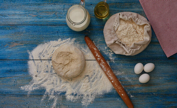 Healthy baking ingredients. Dough recipe ingredients. Flour, sugar, egg, butter on vintage wood table. Ingredients and kitchen items for baking cakes. Top view. Rustic background with text space.