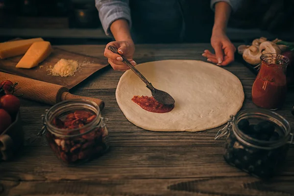 新鲜原始的意大利生比萨饼和木制餐桌上的配料 传统风格的准备 在家庭厨房的木桌上做自制披萨的女人 食物和人概念 — 图库照片