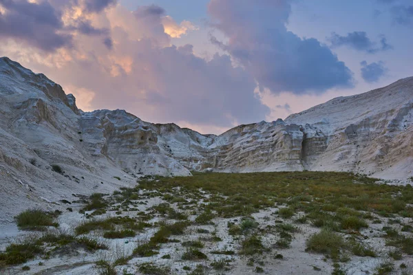 Desert landscape of Gobi Desert, China with a sunset, stones, bushes and the sky. Travel and adventure concept. Ecological tourism