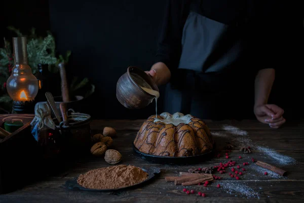 Christmas baking. Cooking homemade cake at home rustic kitchen. Woman\'s hands. Ingredients for cooking christmas baking on dark wooden table. Holidays, winter, Christmas concept. Soft focus.