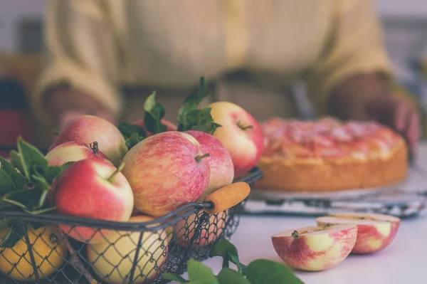 Sweet homemade pie ready to eating. Whole apple pie and a piece is taken out with a cake server. Tasty apple cake served for dessert. Traditional apple pie with cinnamon.