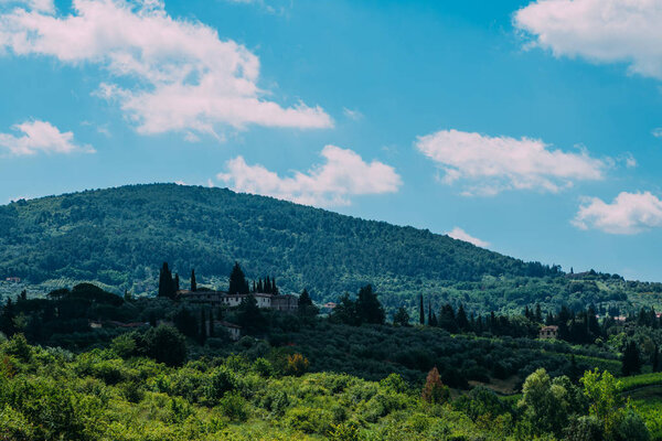 Unique tuscany landscape with farmhouse with olive trees, rolling hills, Tuscany, Italy. Travel. Beautiful destination. Holiday outdoor vacation trip.