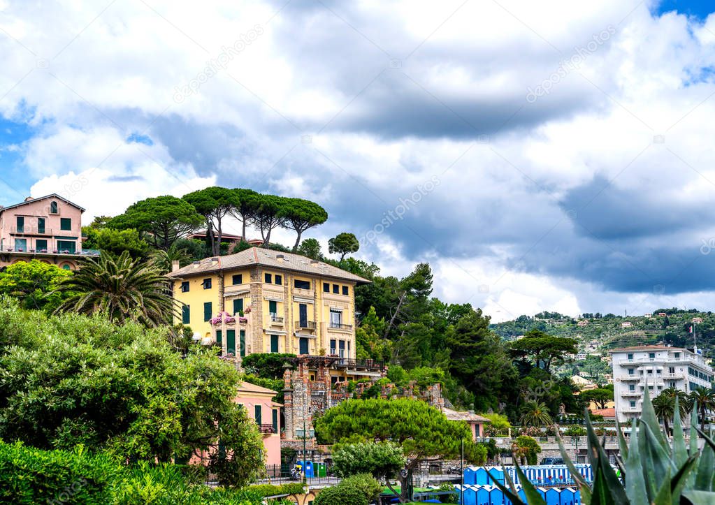 Morning view of Liguria landscape on coastline of mediterranean sea, Italy. View of the picturesque hill with luxury villas. Facades of villas in the lush garden.