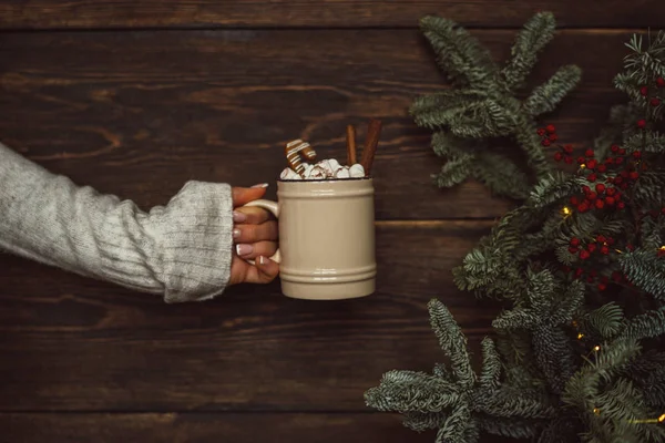 Soft photo of woman with cup of coffee in hand. Woman wearing knitted warm sweater. Winter holidays, hot drinks and people concept. B ig cup coffee or cacao christmas time winter. Toned image.