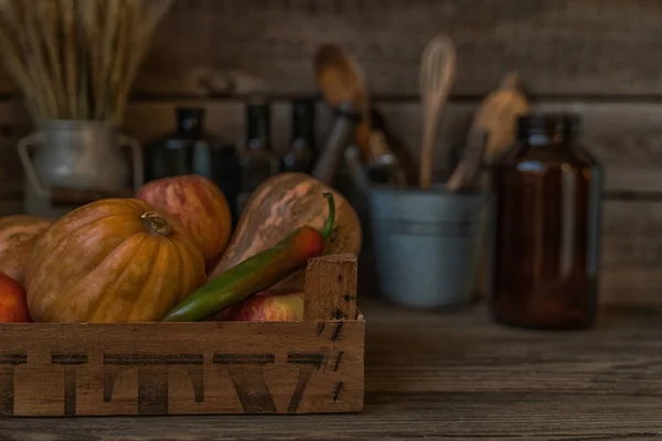 Autumn concept with seasonal vegetables for Thanksgiving Day. Fresh vegetables on dark table. Healthy eating. Squash, pumpkins and apples. Recipes or menu card. Flat lay, copy space. Toned image.