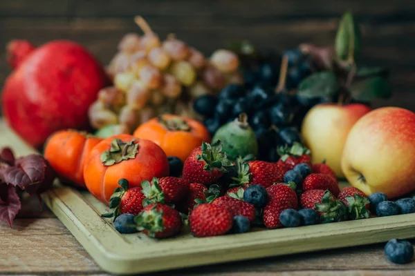 Assorted fresh ripe fruits and vegetables. Food concept background. Organic food. Fresh raw fruits and berries. Autnum harvest. Toned vintage image. Soft focus.
