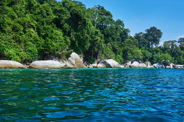 Tropical paradise island and blue sky turquoise water and granite rocks. Travel tourism background. Amazing tropical holidays in paradise beaches of Tioman island, Malaysia.
