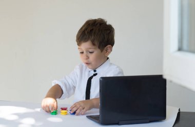 Sürpriz çocuk. Ofis içinde bir laptop önünde oturan genç iş çocuk.