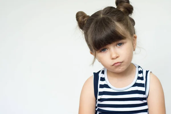 Portrait of stylish child  with bored fed up expression, looks displeased up and being tired.