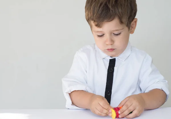 Kid counting his play money on white background. Learning financial responsibility and planning savings concept.