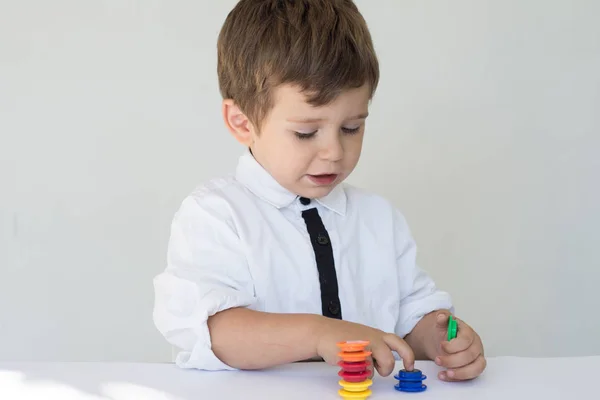 Kid counting his play money on white background. Financial responsibility and financial education concept.