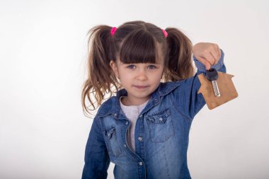 Child holding house keys on house shaped keychain like Real Estate Agent  clipart